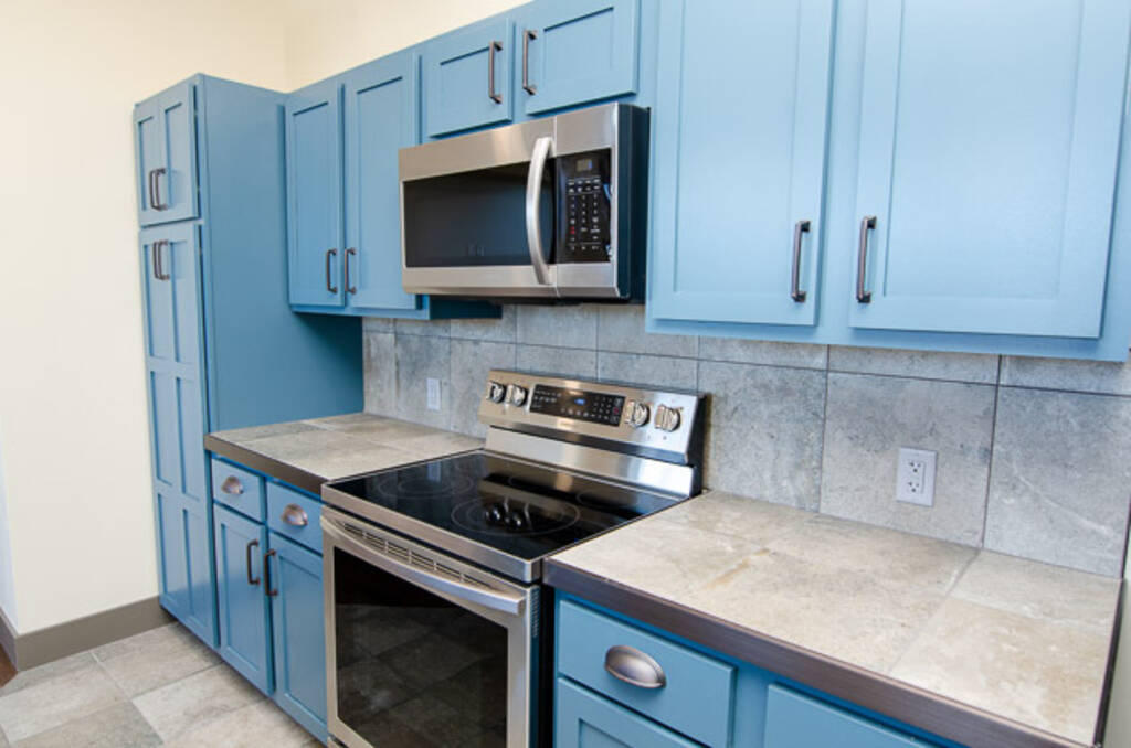 LOFT 3A BLUE KITCHEN CABINETS STOVE AND MICROWAVE