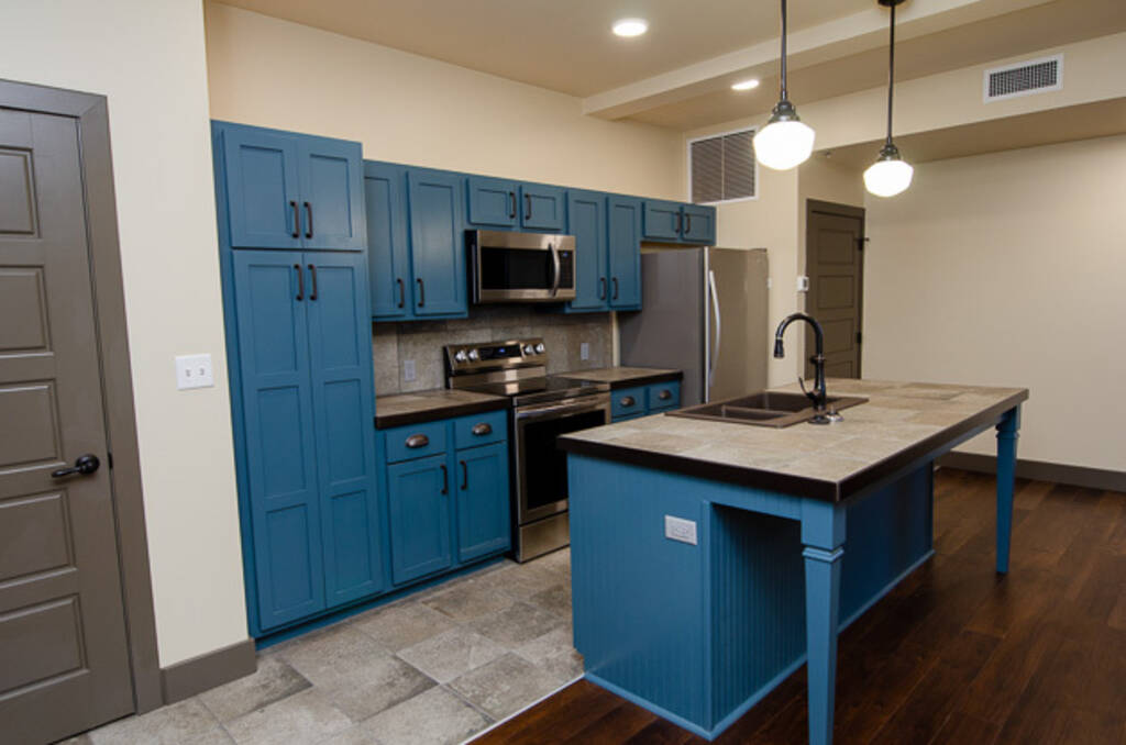 LOFT 3B KITCHEN WITH BLUE ISLAND AND BLUE CABINETS 