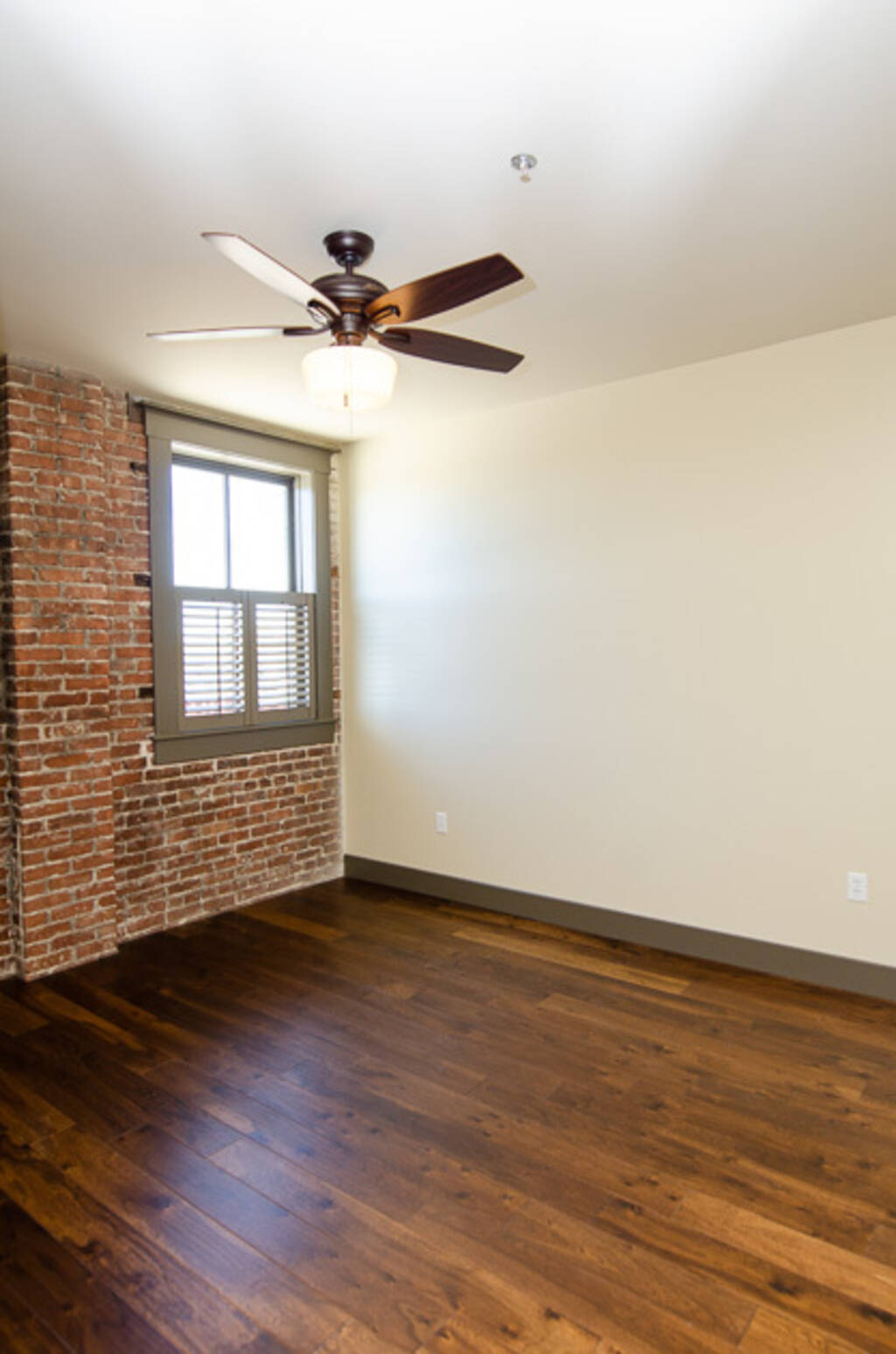 LOFT 3C BEDROOM CEILING FAN AND BRICK WALL WITH WINDOW