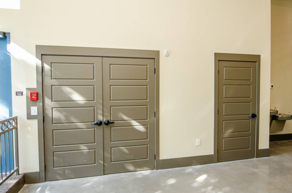 Suite A Three Grey door entrances into storage and electrical rooms 