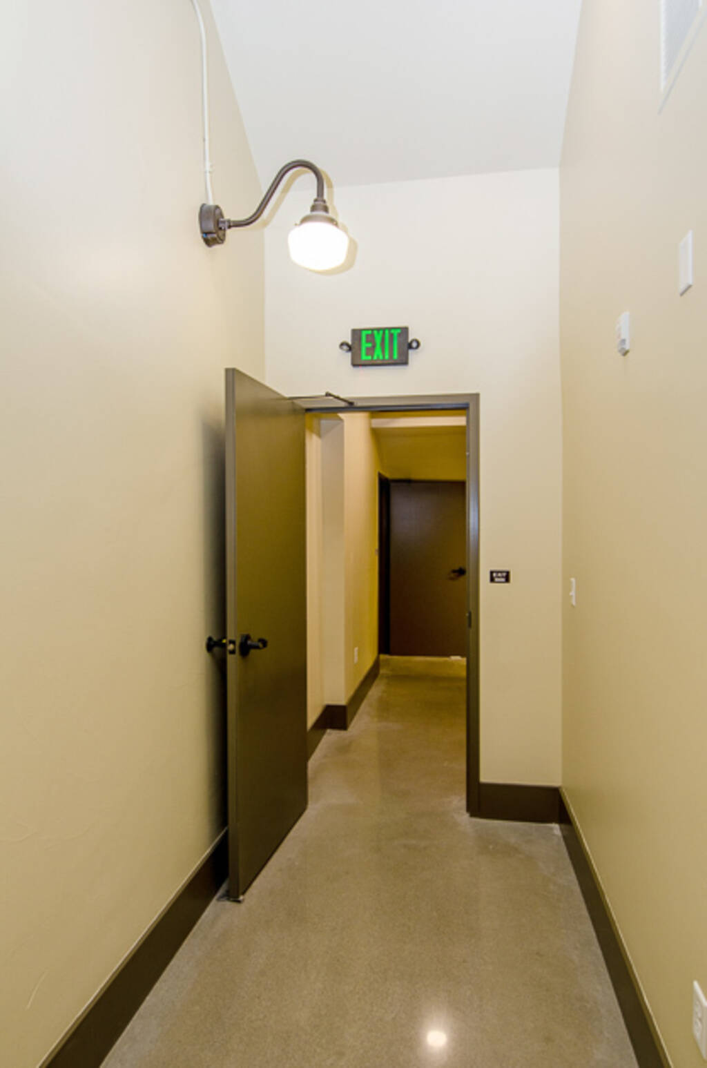 Suite A Green exit sign and exit door open 